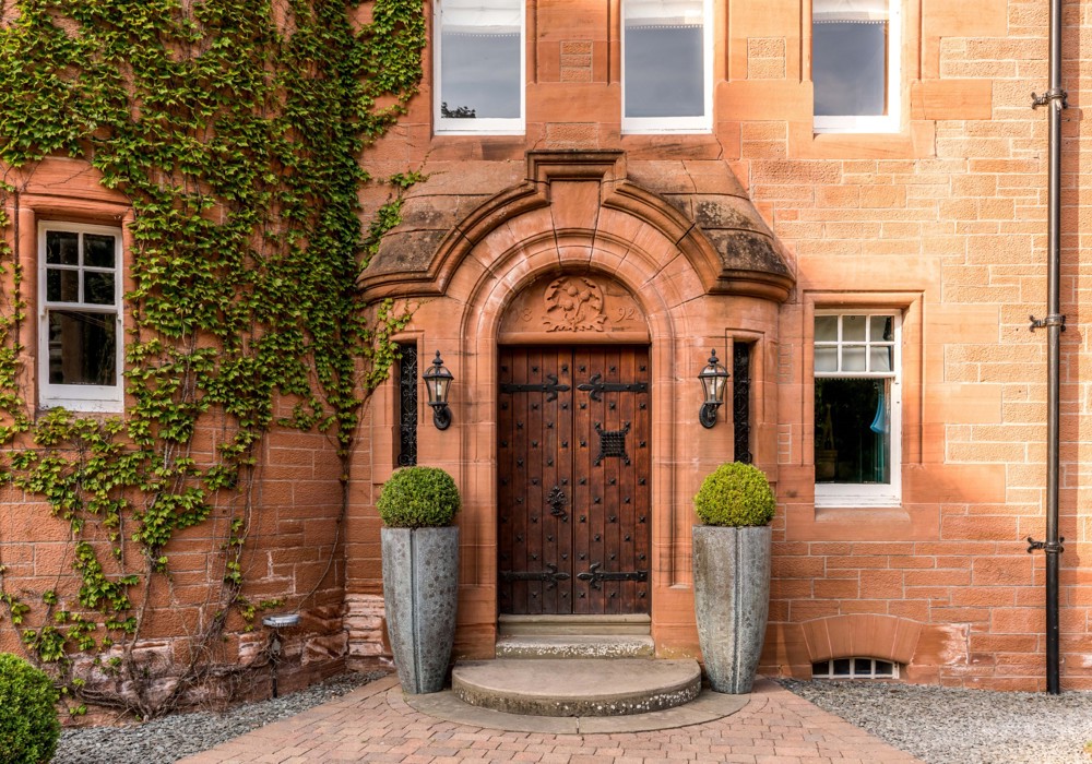 Wooden Castle Doors Surrounded by Brick With Ivy at Fonab Castle Hotel in Pitlochry ?? ''
